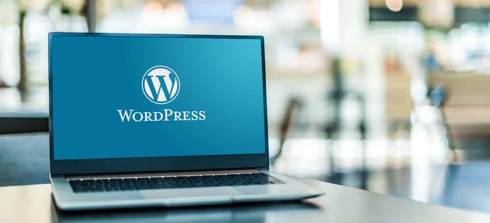 wordpress logo and text open on laptop