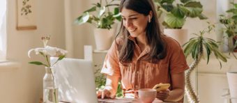 a woman sitting at a table with a laptop